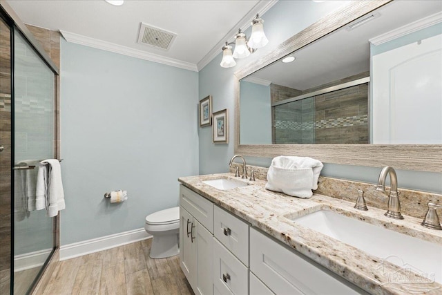 bathroom featuring crown molding, a shower with shower door, hardwood / wood-style floors, and toilet