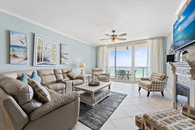 living room featuring crown molding, a wall of windows, ceiling fan, and light tile patterned flooring