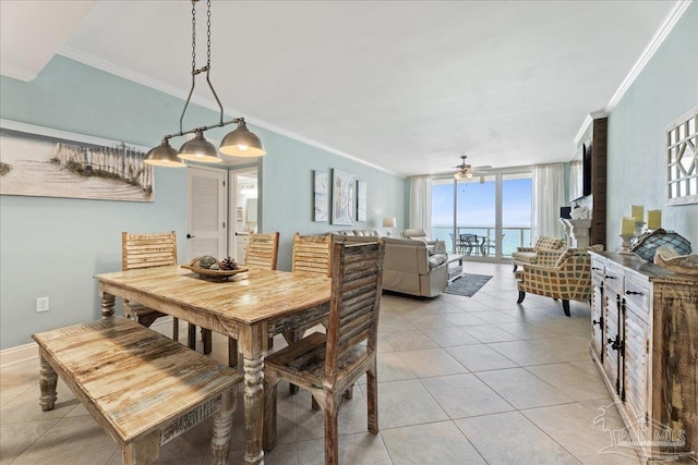 tiled dining area with crown molding, ceiling fan, and a wall of windows