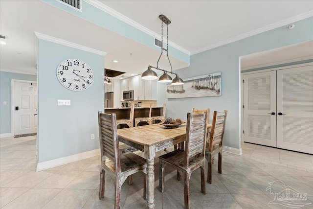 dining space with crown molding and light tile patterned floors