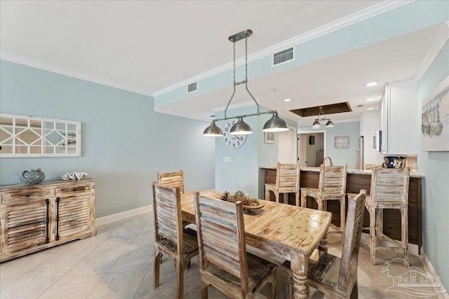 dining room with crown molding and light tile patterned flooring