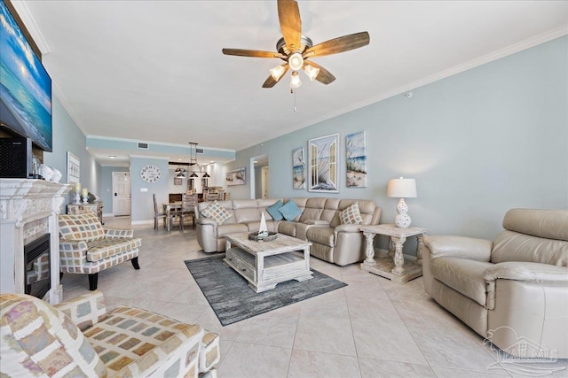 living room featuring crown molding, light tile patterned floors, and ceiling fan