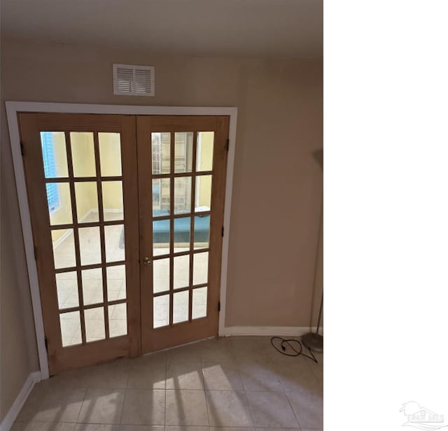 doorway featuring french doors and light tile patterned floors