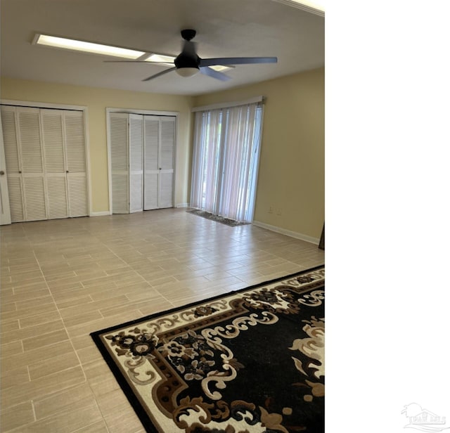 bedroom with multiple closets and ceiling fan