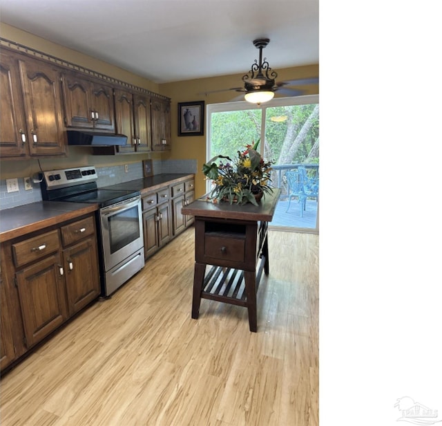 kitchen with ceiling fan, dark brown cabinets, stainless steel range with electric cooktop, and light wood-type flooring