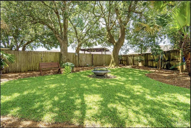 1707 Cedrus Ln, Pensacola, FL 32514 - fenced backyard with a fire pit