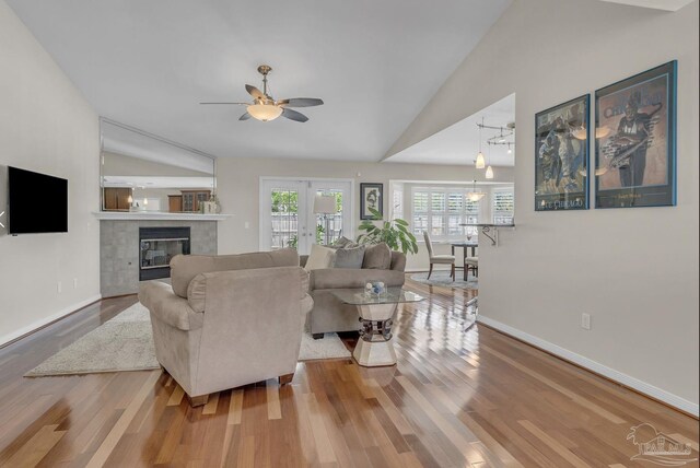 1707 Cedrus Ln, Pensacola, FL 32514 - living area featuring vaulted ceiling, ceiling fan, wood finished floors, and a tiled fireplace
