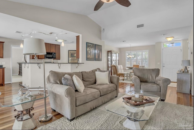 1707 Cedrus Ln, Pensacola, FL 32514 - living area with light wood-style flooring, ceiling fan, and vaulted ceiling