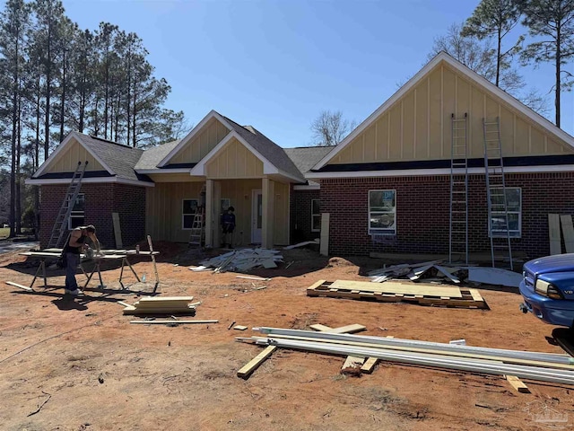 view of front facade featuring board and batten siding and brick siding