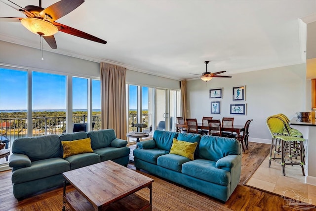 living room featuring ornamental molding, ceiling fan, and light hardwood / wood-style floors