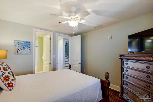 bedroom with dark hardwood / wood-style floors and ceiling fan