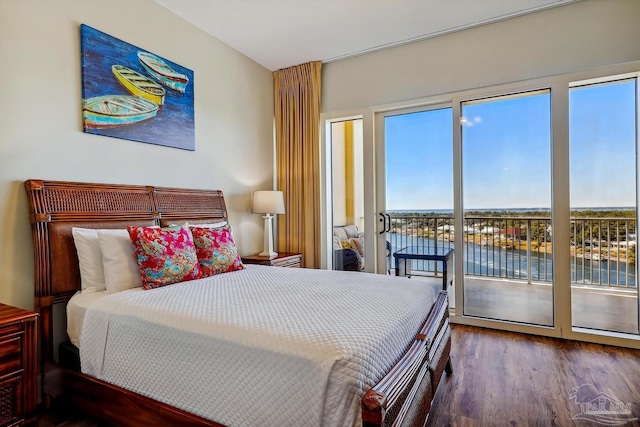 bedroom with a water view, access to exterior, and dark hardwood / wood-style flooring