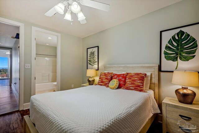 bedroom with ceiling fan, ensuite bath, and dark wood-type flooring