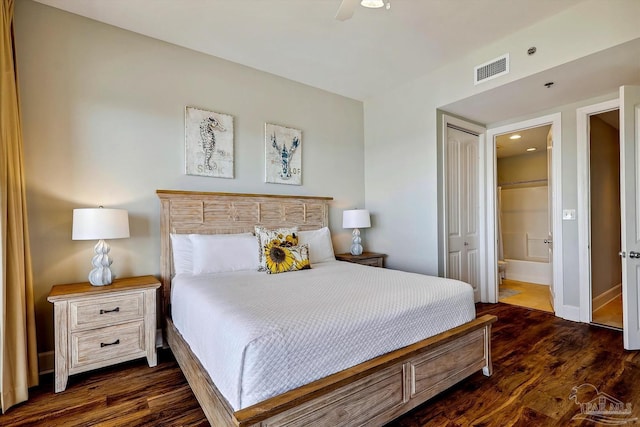 bedroom featuring dark wood-type flooring, ceiling fan, ensuite bathroom, and a closet