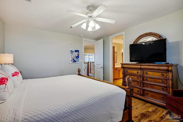 bedroom featuring ensuite bath, dark hardwood / wood-style floors, and ceiling fan