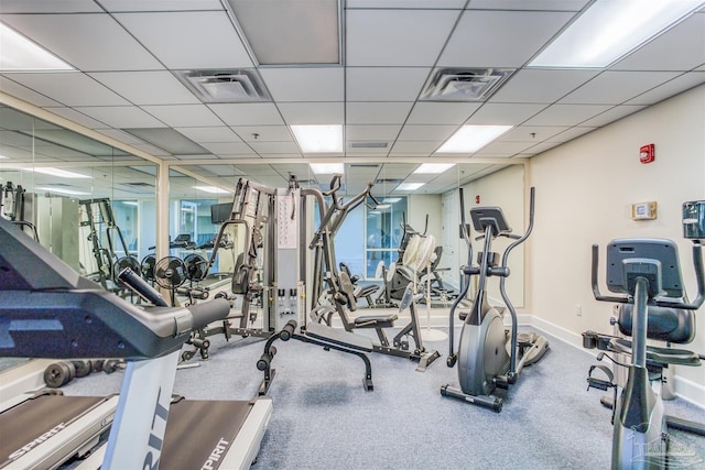 workout area with a paneled ceiling