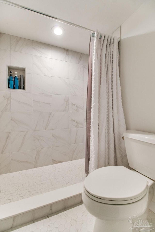 full bathroom with toilet, a shower stall, and recessed lighting