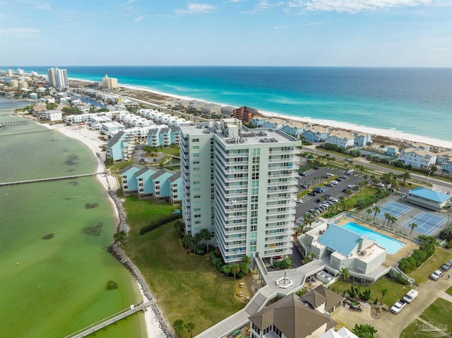 aerial view with a water view and a beach view