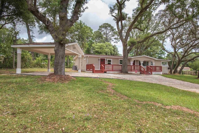 view of front of property featuring driveway, a front yard, a wooden deck, a carport, and central air condition unit