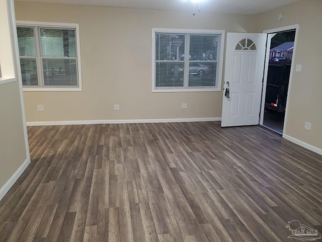 empty room with dark wood-type flooring