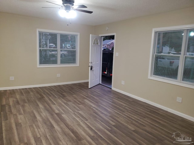 unfurnished bedroom featuring ceiling fan, dark hardwood / wood-style floors, a textured ceiling, and a closet