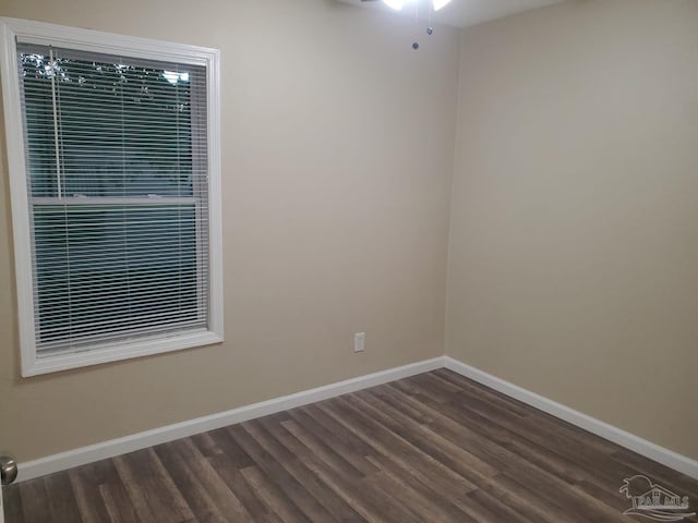 unfurnished room with dark hardwood / wood-style floors