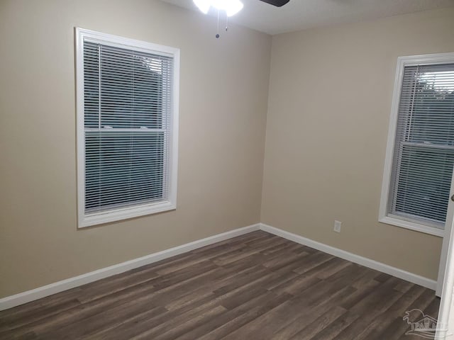 spare room featuring dark hardwood / wood-style floors, ceiling fan, and a textured ceiling