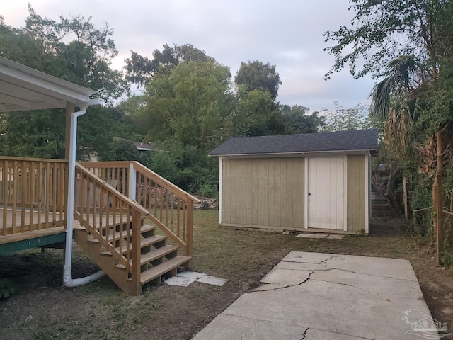 view of yard featuring a shed and a deck