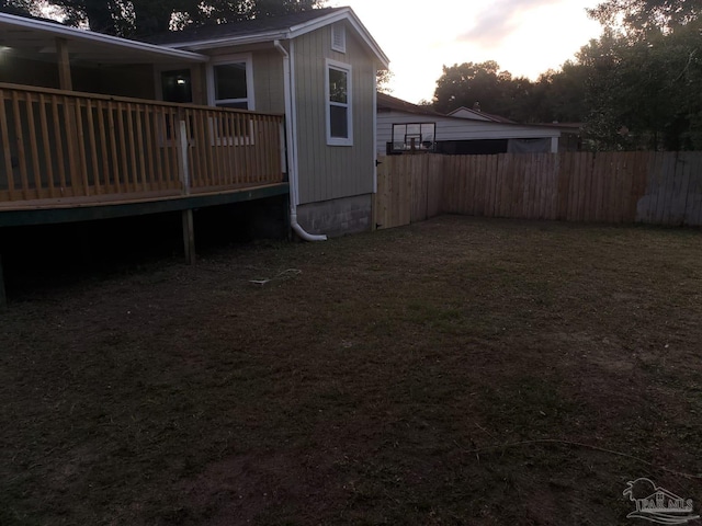 yard at dusk with a wooden deck