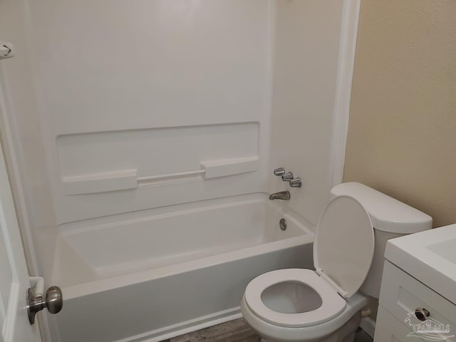 full bathroom featuring toilet, wood-type flooring, vanity, and bathing tub / shower combination