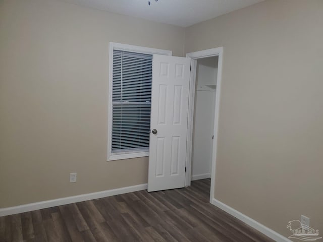 empty room featuring dark wood-type flooring