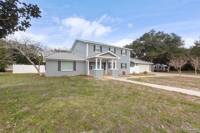 view of front of home with a garage, brick siding, a front yard, and fence