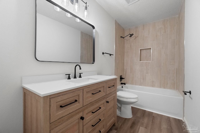 5547 Kauffman Rd, Milton, FL 32583 - full bathroom with toilet, vanity, wood finished floors, bathing tub / shower combination, and a textured ceiling