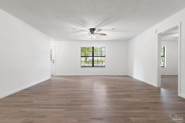 5547 Kauffman Rd, Milton, FL 32583 - unfurnished room with healthy amount of natural light, ceiling fan, wood finished floors, a textured ceiling, and baseboards