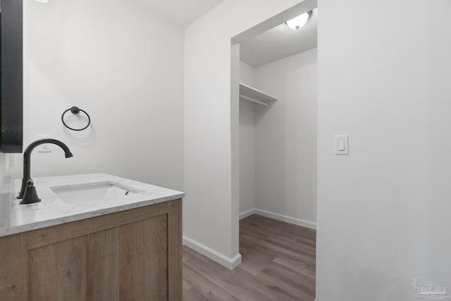 5547 Kauffman Rd, Milton, FL 32583 - bathroom with wood finished floors, vanity, and baseboards