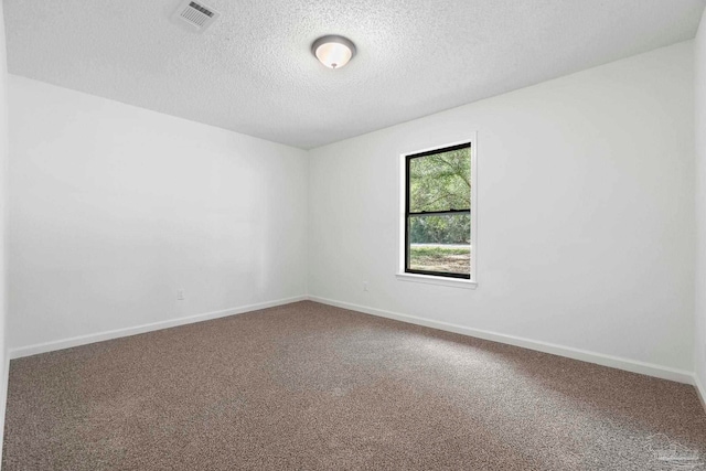 5547 Kauffman Rd, Milton, FL 32583 - empty room featuring a textured ceiling, carpet floors, and baseboards