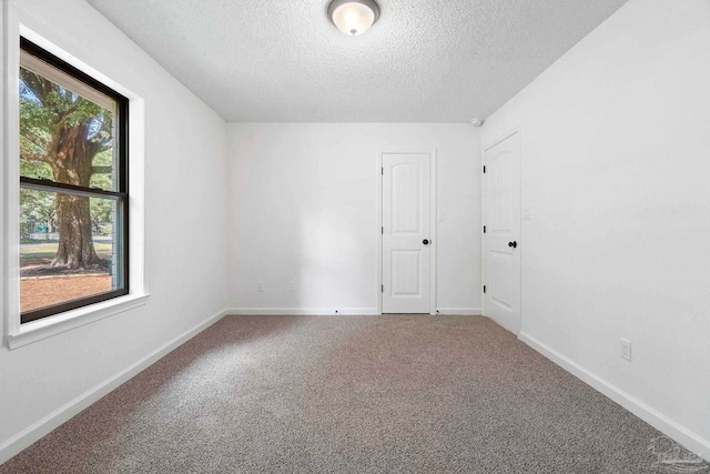 5547 Kauffman Rd, Milton, FL 32583 - carpeted empty room featuring a textured ceiling and baseboards