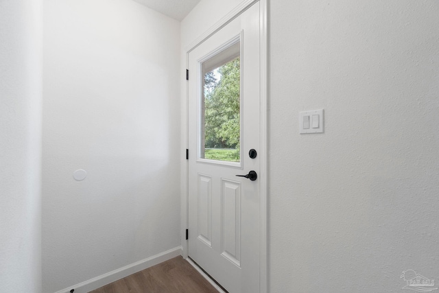 5547 Kauffman Rd, Milton, FL 32583 - doorway featuring dark wood-type flooring and baseboards