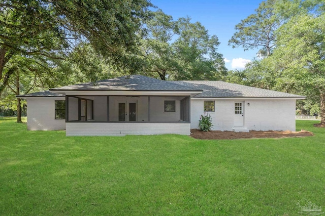 5547 Kauffman Rd, Milton, FL 32583 - rear view of property featuring a sunroom, a lawn, french doors, and roof with shingles