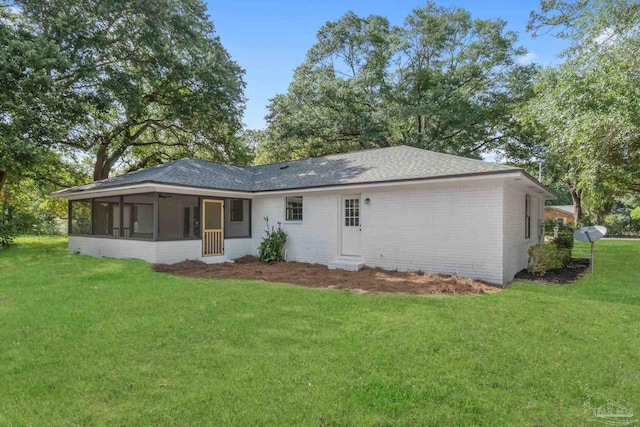 5547 Kauffman Rd, Milton, FL 32583 - back of property with a sunroom, a yard, roof with shingles, and brick siding