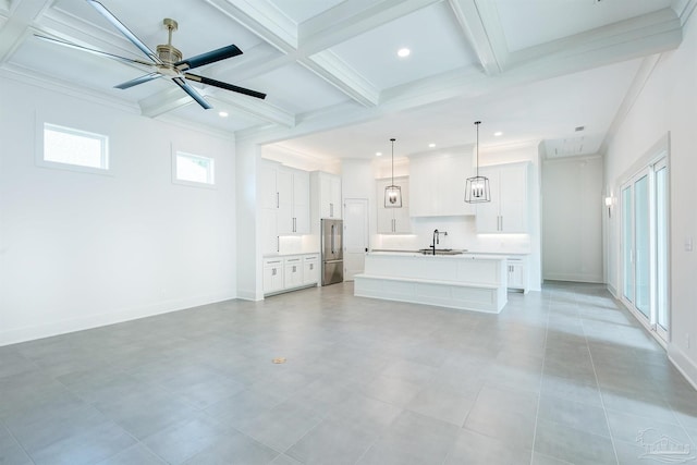 unfurnished living room with light tile patterned flooring, ceiling fan, beamed ceiling, coffered ceiling, and sink