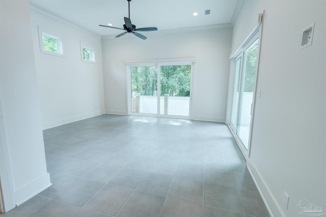 unfurnished room featuring tile patterned floors, ornamental molding, and ceiling fan