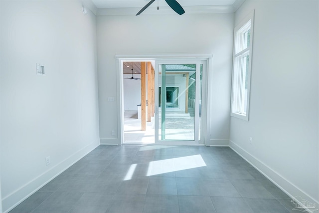 tiled empty room with ceiling fan