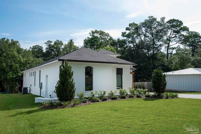 view of front of property featuring central AC and a front yard