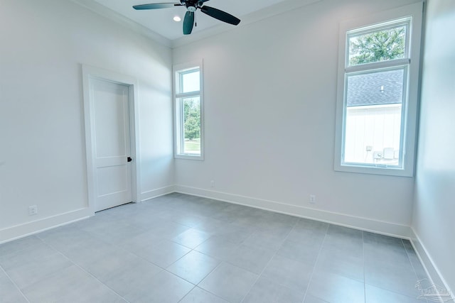 tiled spare room with ceiling fan