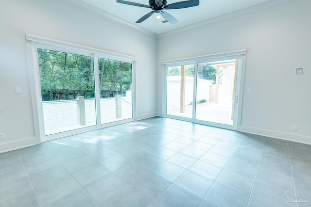 tiled spare room with crown molding and ceiling fan