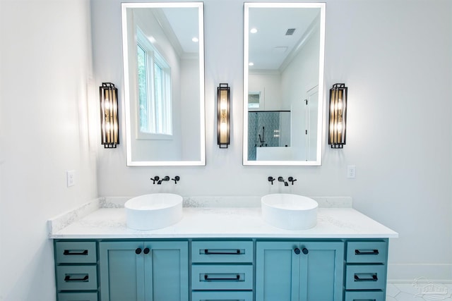 bathroom with dual vanity, crown molding, and tile patterned floors