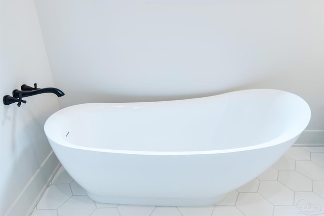 bathroom featuring tile patterned floors and a tub to relax in