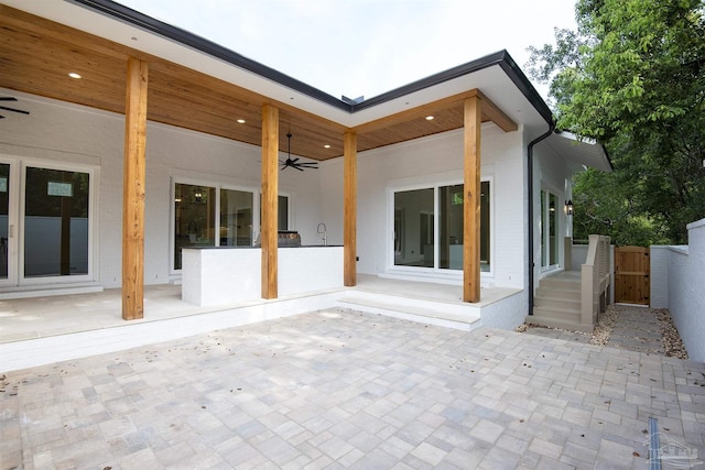 rear view of property with a patio and ceiling fan