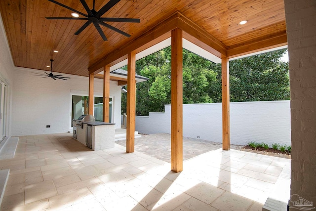 view of patio with area for grilling and ceiling fan